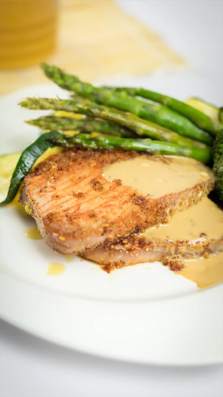 Wasabi sauce glazed tuna steaks with sauteed asparagus.