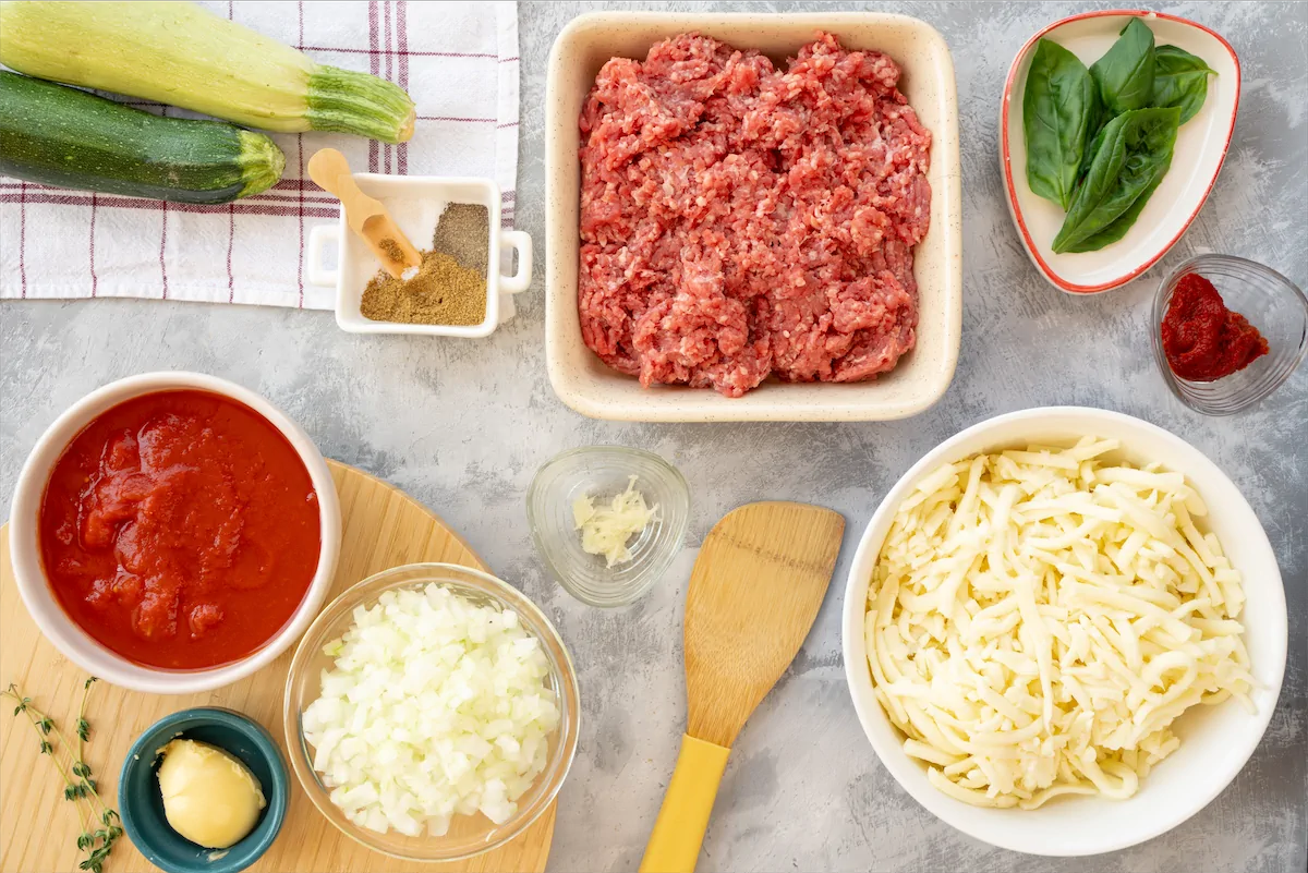 Ingredients made ready for the preparation of beef and zucchini lasagna recipe.