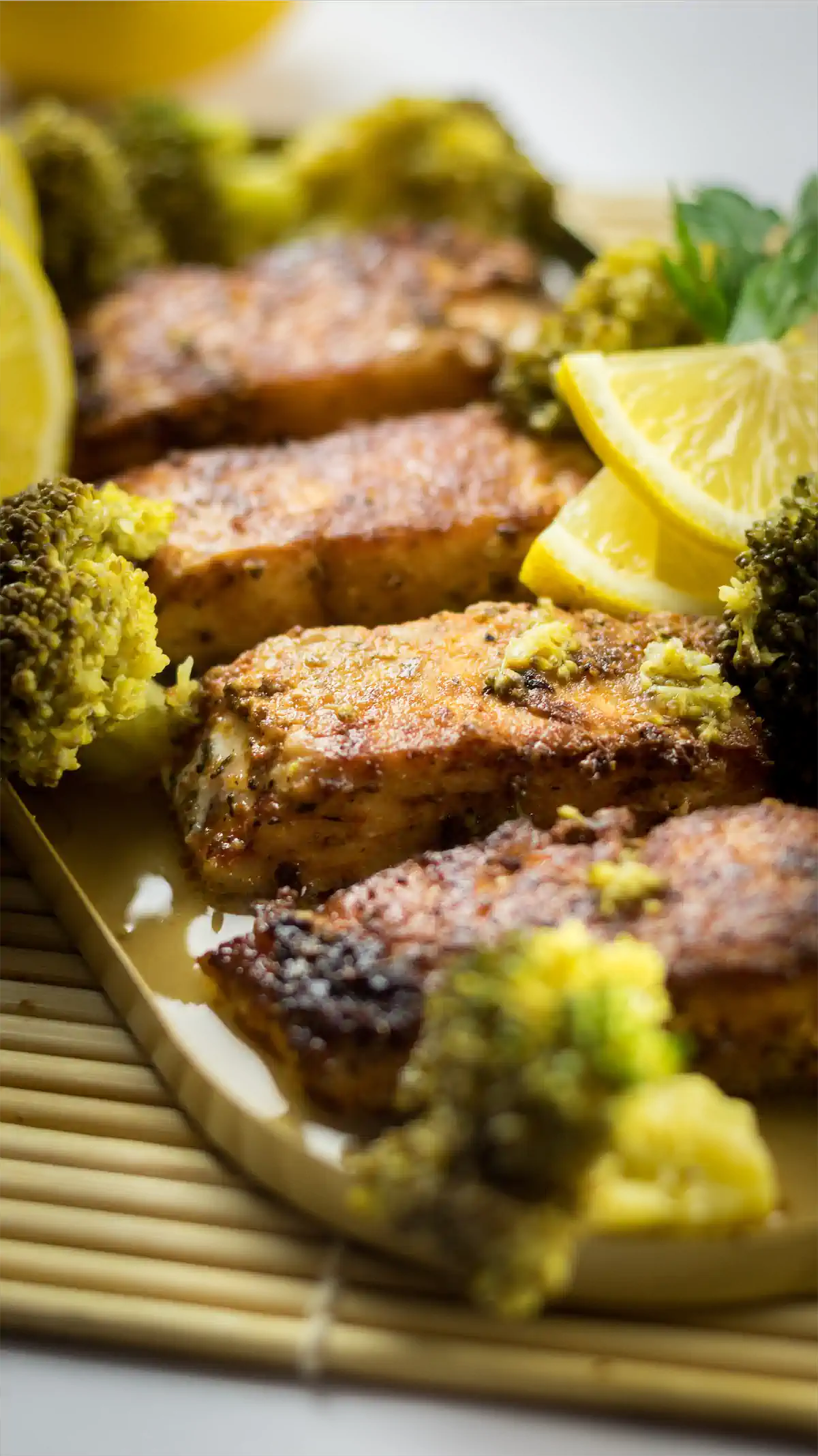 Pan-seared salmon seasoned with blackened spices, drizzled with a lemony butter sauce, and served alongside broccoli.