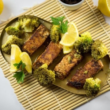 Blackened salmon recipe in lemon butter sauce and steamed broccoli.
