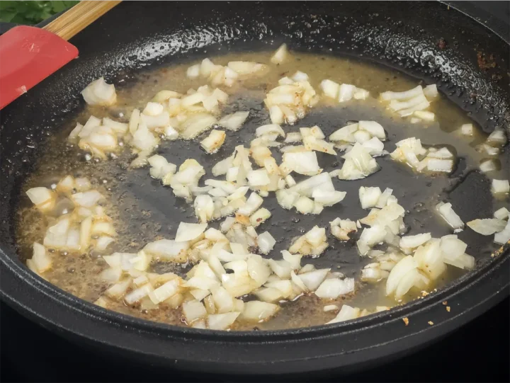Cooking onions in a cast iron pan with butter.