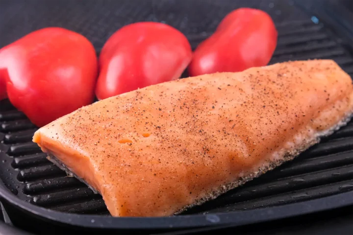 Grilling salmon in cast iron grill pan.