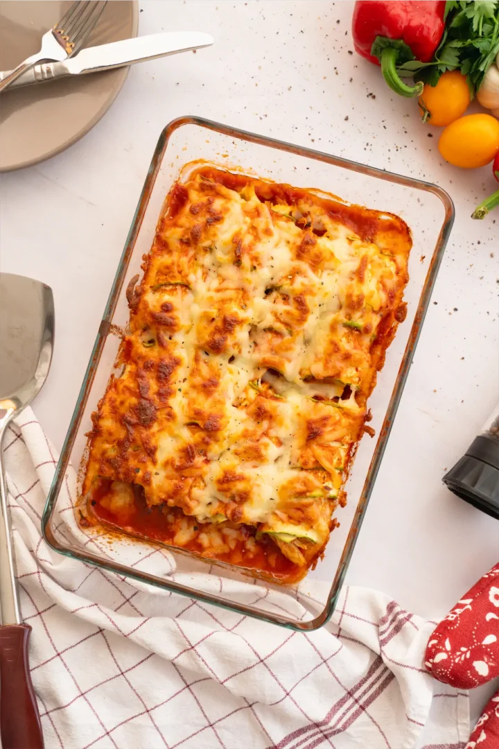 Baked zucchini enchiladas in a glass dish ready to be served.