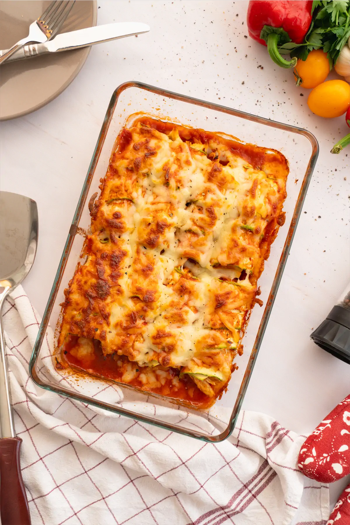 Baked zucchini enchiladas in a glass dish ready to be served. 