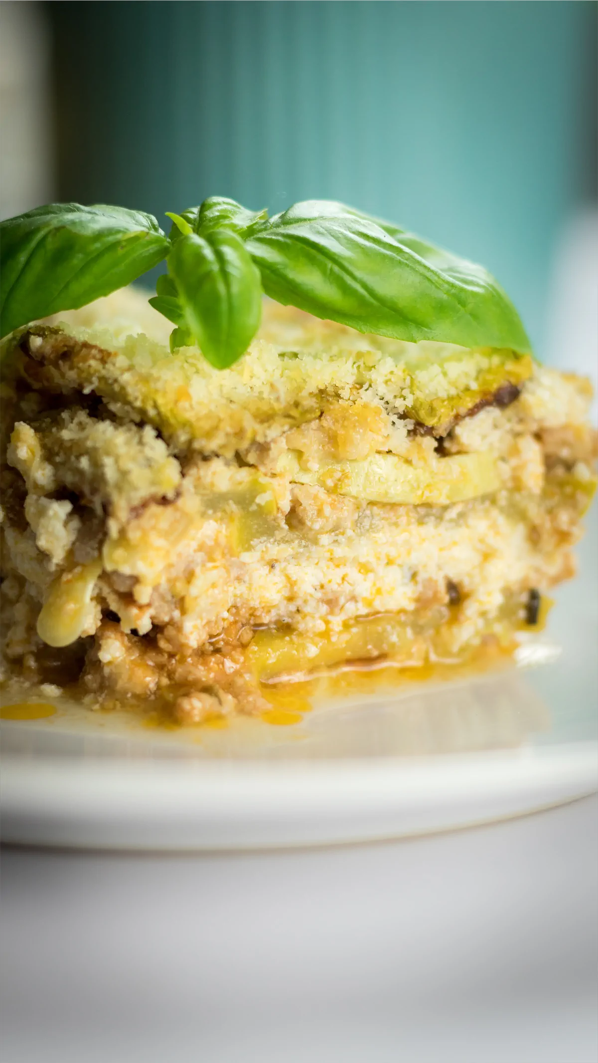 Lasagna with zucchini served on a plate, showcasing its distinct layers.