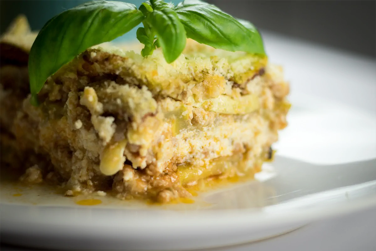 A close-up picture of keto zucchini lasagna served on a plate, showcasing its layers.