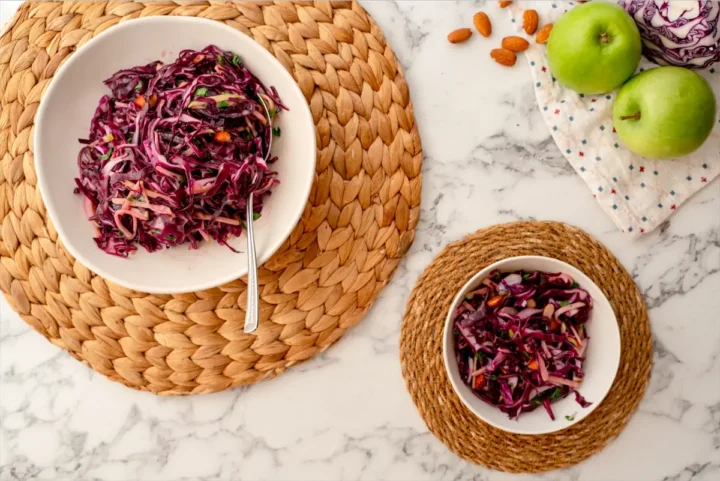 Two bowls of red cabbage salad.