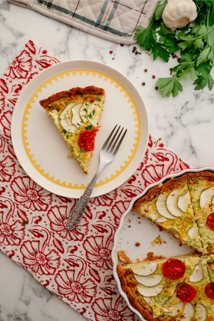 Slice of quiche served on a plate.
