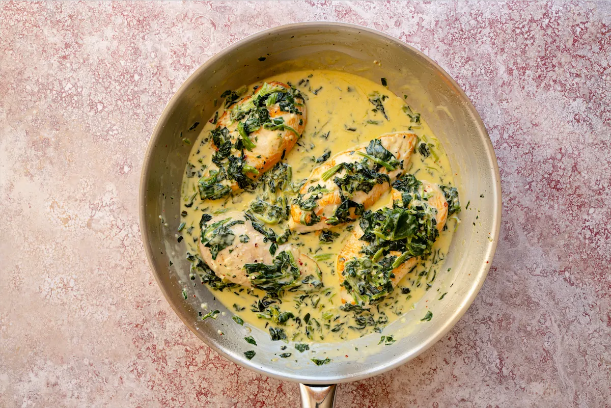 Low-carb chicken Florentine in a stainless steel skillet ready to be served.