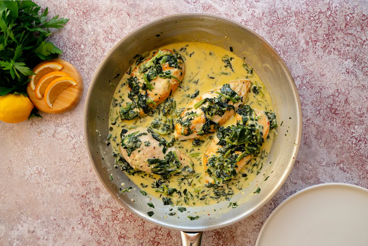 Homemade creamy chicken Florentine prepared in a stainless steel pan, all set for serving.