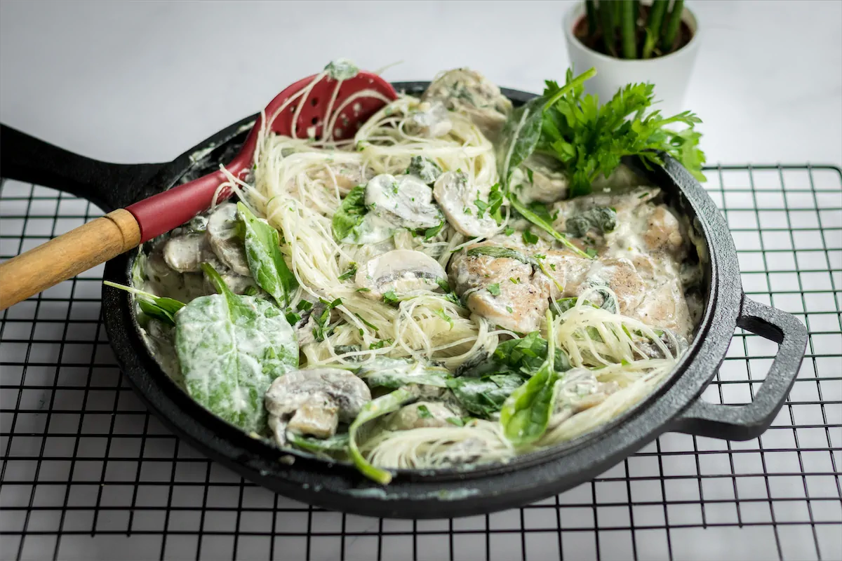 Low-carb creamy chicken mushroom cooked in a cast iron skillet, prepared and waiting to be served.