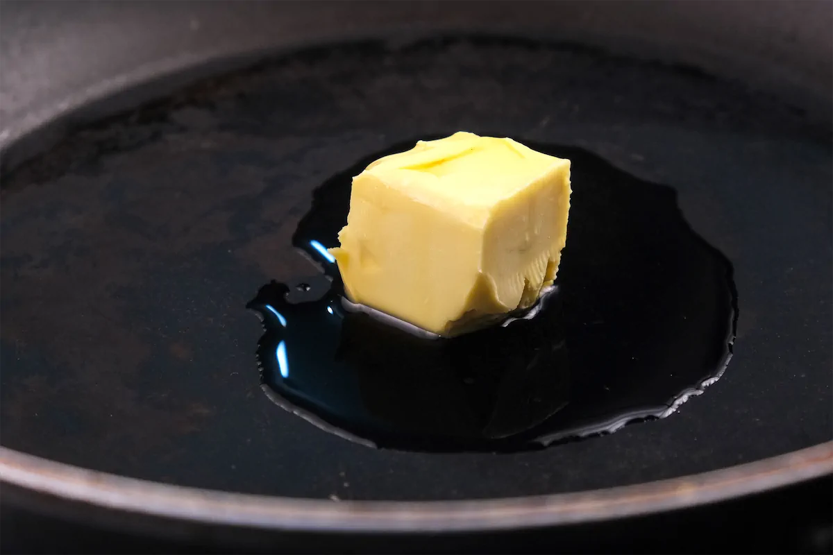 Heating ghee and butter in a cast iron pan.
