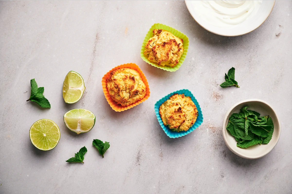 Freshly baked mojito cupcakes in colorful silicone molds.