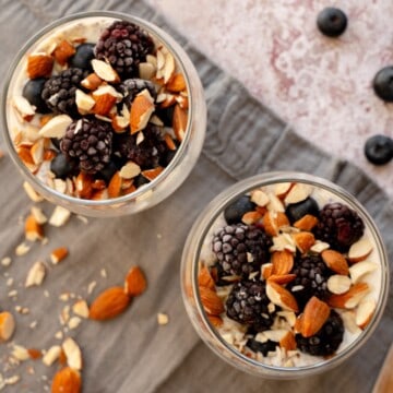 Overnight oats topped with nuts and berries served in glass jars.