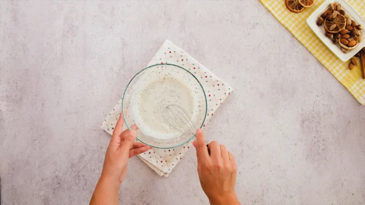 The yogurt, almond milk, chia seeds, and other ingredients are getting whisked for the overnight oats.