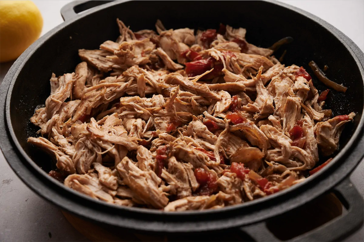 Homemade keto pulled chicken in a cast iron skillet.