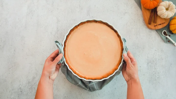 Baking dish with pumpkin pie filling is ready to be baked.