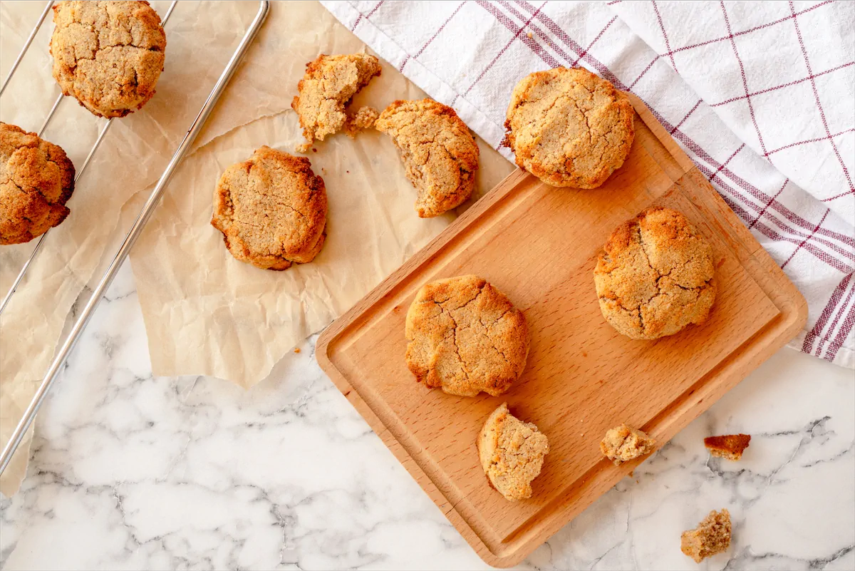 Homemade pumpkin spice cookies displayed artfully while some are snapped open.