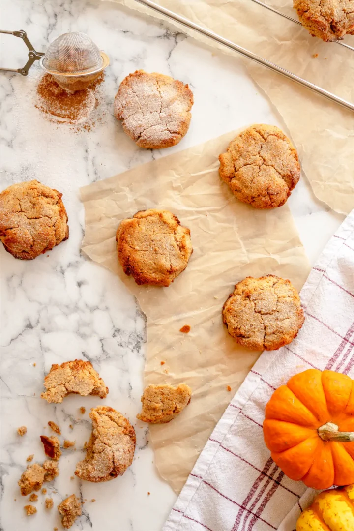 Homemade low-carb pumpkin spice cookies displayed on the table while one is snapped.