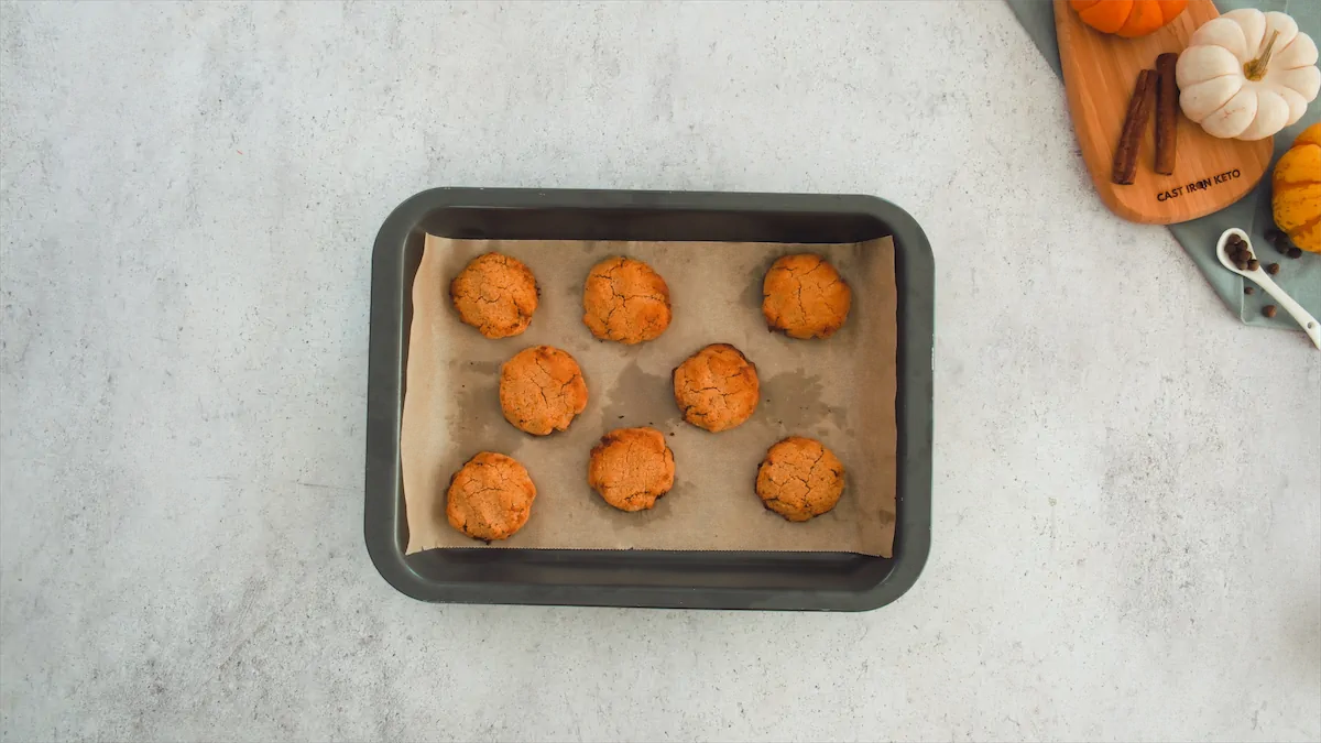 Freshly baked pumpkin spice cookies on a rectangular baking tray.