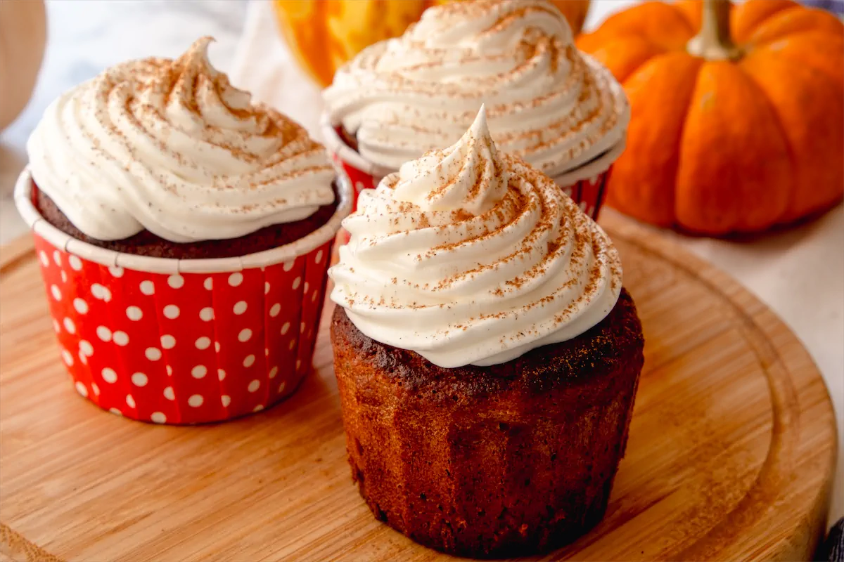 A delightful keto cupcake with pumpkin spice latte, whipped cream, and pumpkin spice.