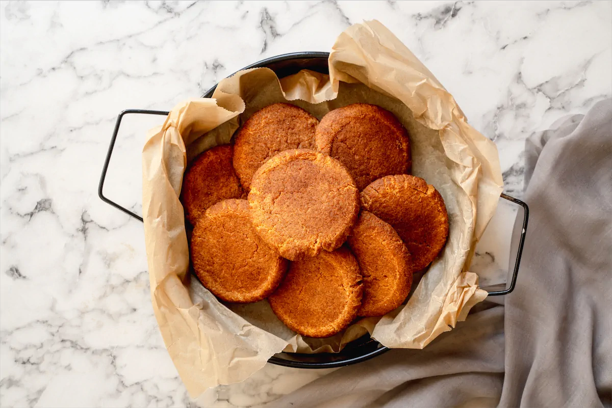 Freshly baked sugar-free and low-carb snickerdoodles displayed on a deep skillet lined with parchment paper.