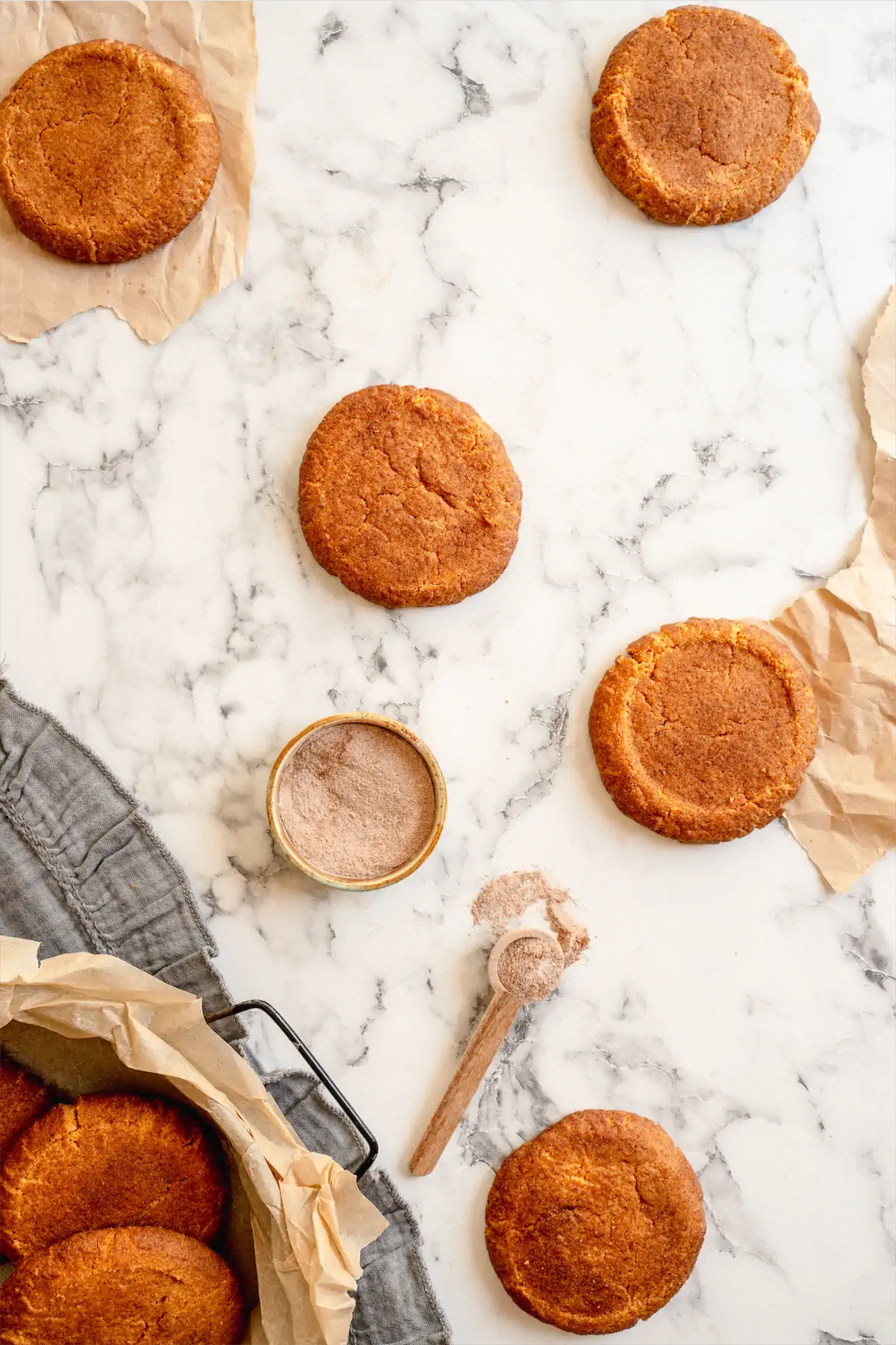 Sugar-free keto snickerdoodles presented on the table ready to be sprinkled with a mixture of granulated erythritol and ground cinnamon.