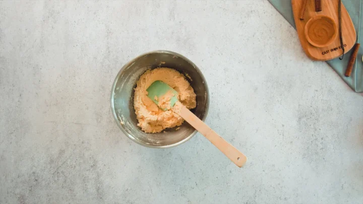 The snickerdoodle cookie dough, in a bowl with a resting silicone spatula.