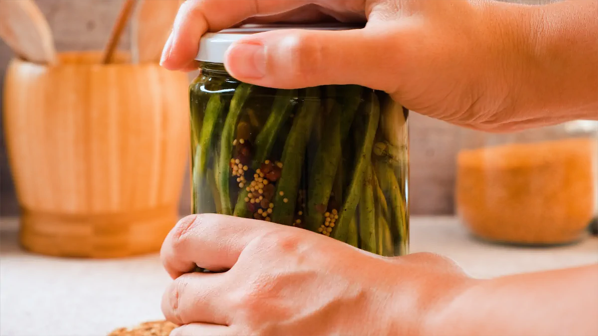 Closing the lid of glass jar with green beans and brine for pickling.
