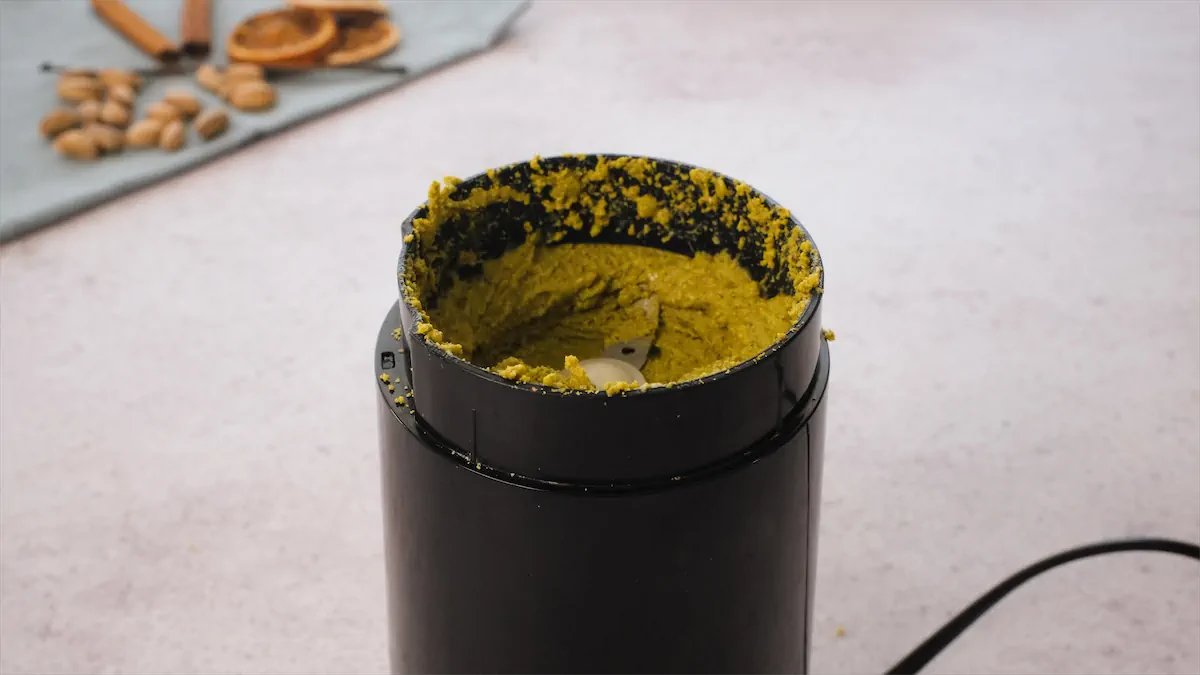 An electric blender with Pistachio butter ready to be served.
