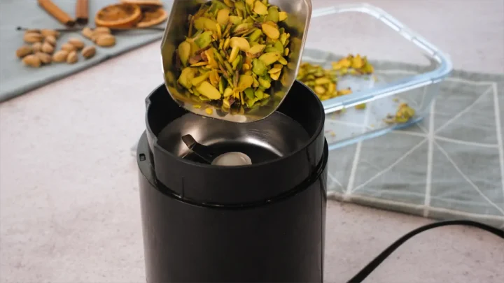 Roasted pistachios are about to be added to the electric blender.