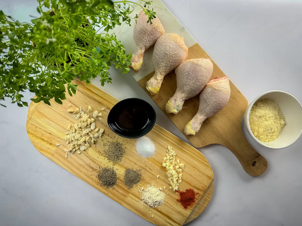 All the ingredients required to make baked chicken legs are measured and arranged on the table.