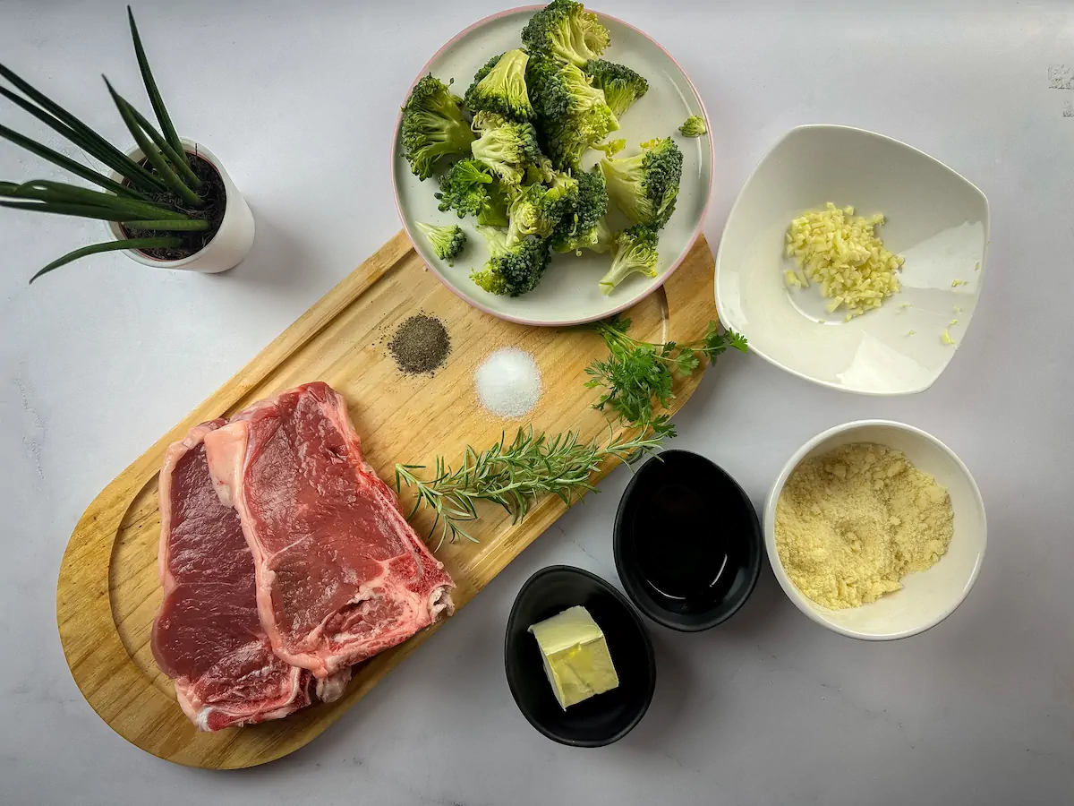 All the ingredients required to make baked ribeye steak gathered and arranged on the table.