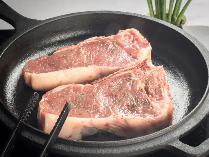 Cooking the ribeye steak on a cast iron skillet.