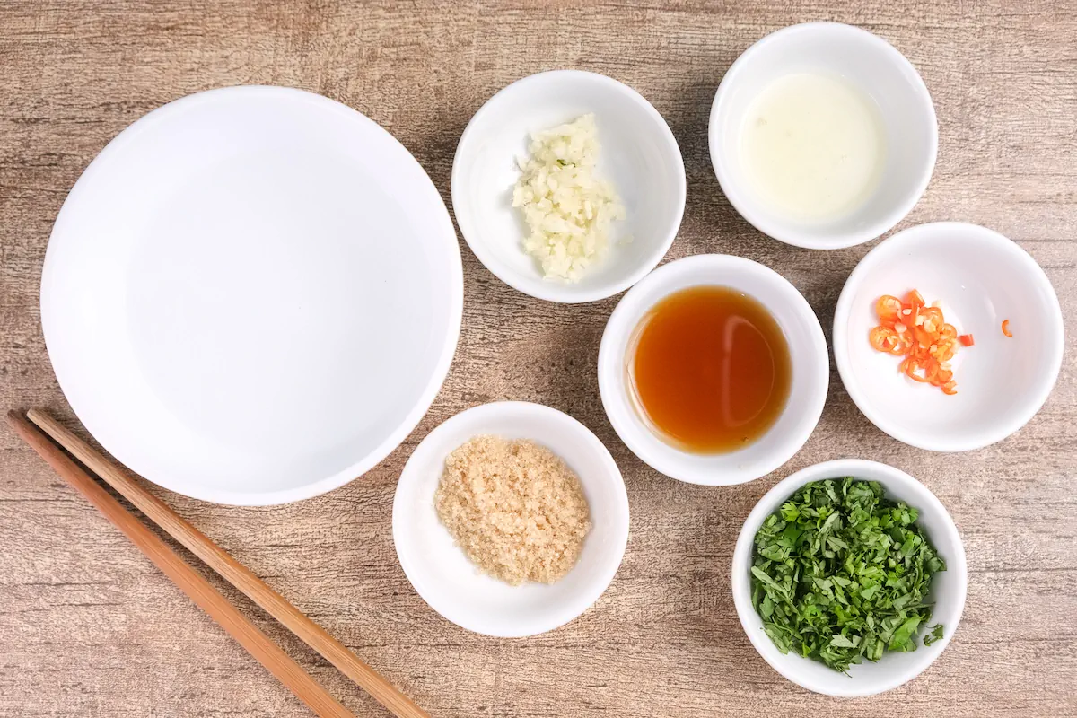 All the ingredients required to make the dipping sauce measured and gathered on the table.