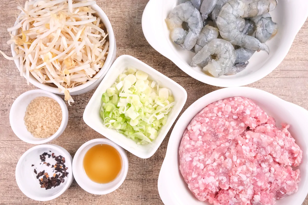 All the ingredients required to make banh xeo filling gathered and arranged on the table.