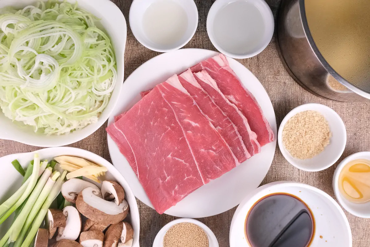 All the ingredients required to make Japanese beef ramen are arranged and displayed on the table.