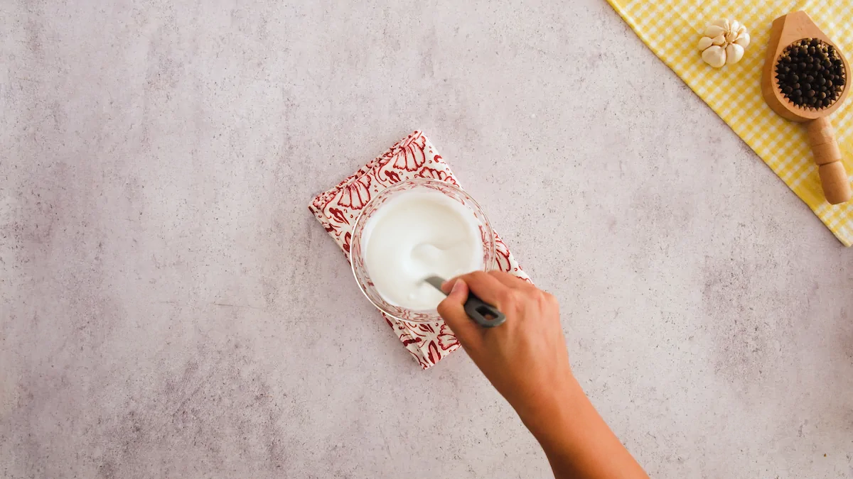 Whisking the yogurt and unsweetened coconut milk in a small bowl.