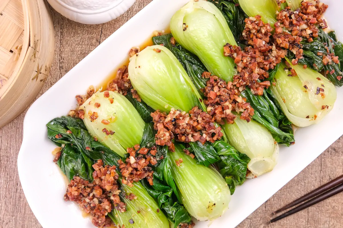 Homemade Chinese keto bok choy with Chorizo presented on a rectangular serving dish.