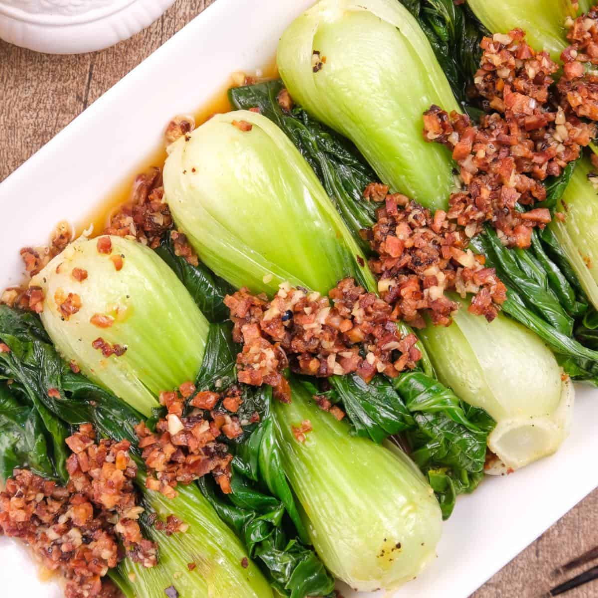 Chinese keto bok choy with chorizo served on a rectangular platted.