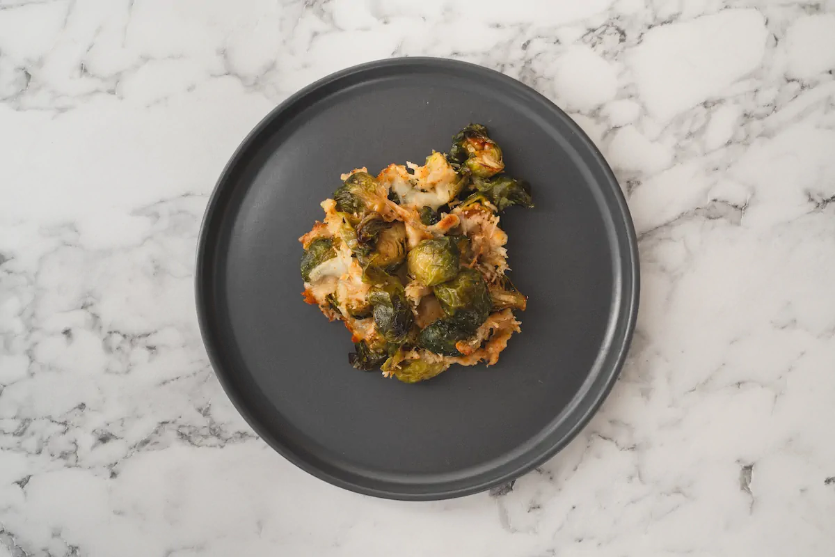 Cheesy Brussels sprouts served on a plate.