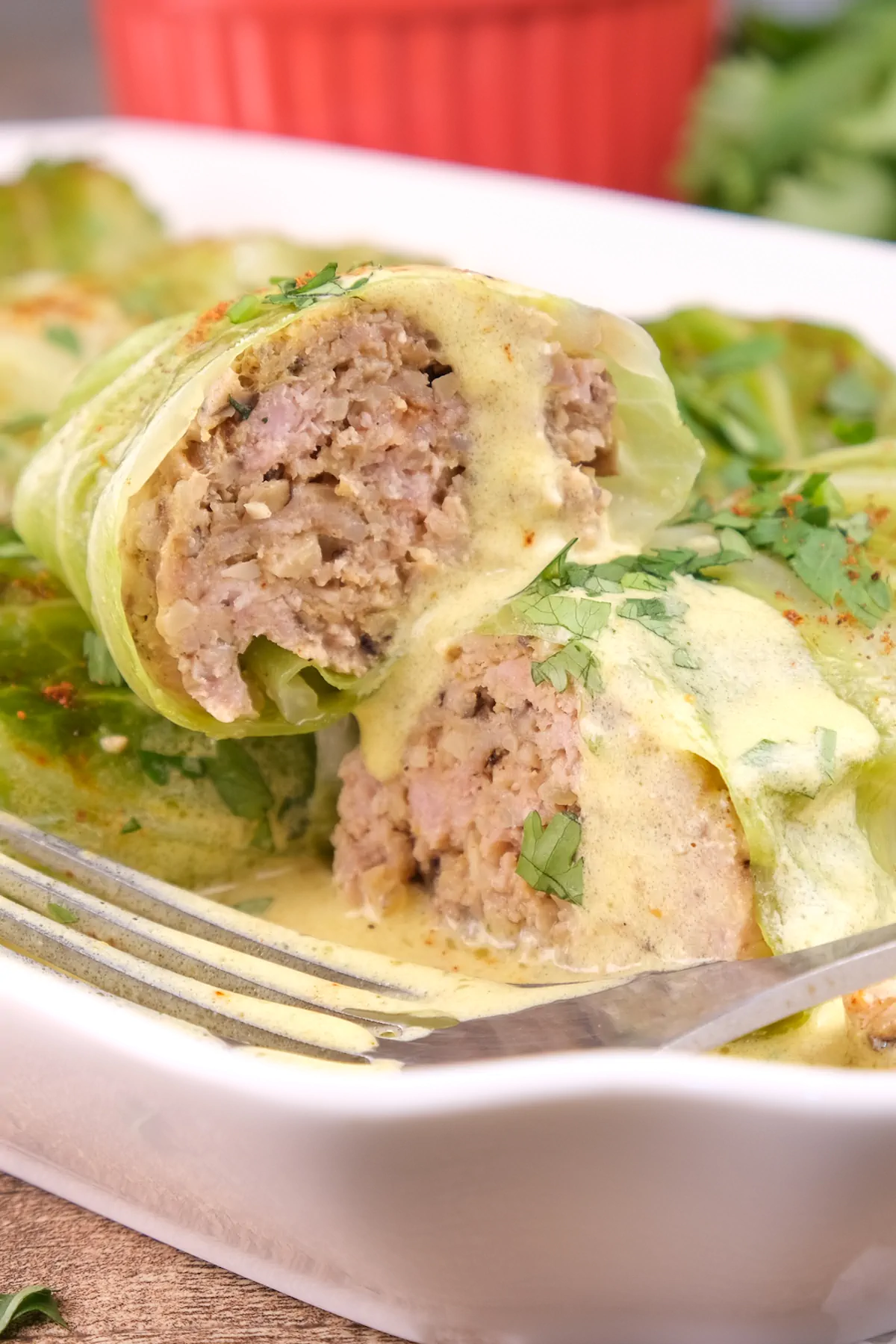 An up-close view of keto cabbage rolls that have been sliced, revealing the pork stuffing.