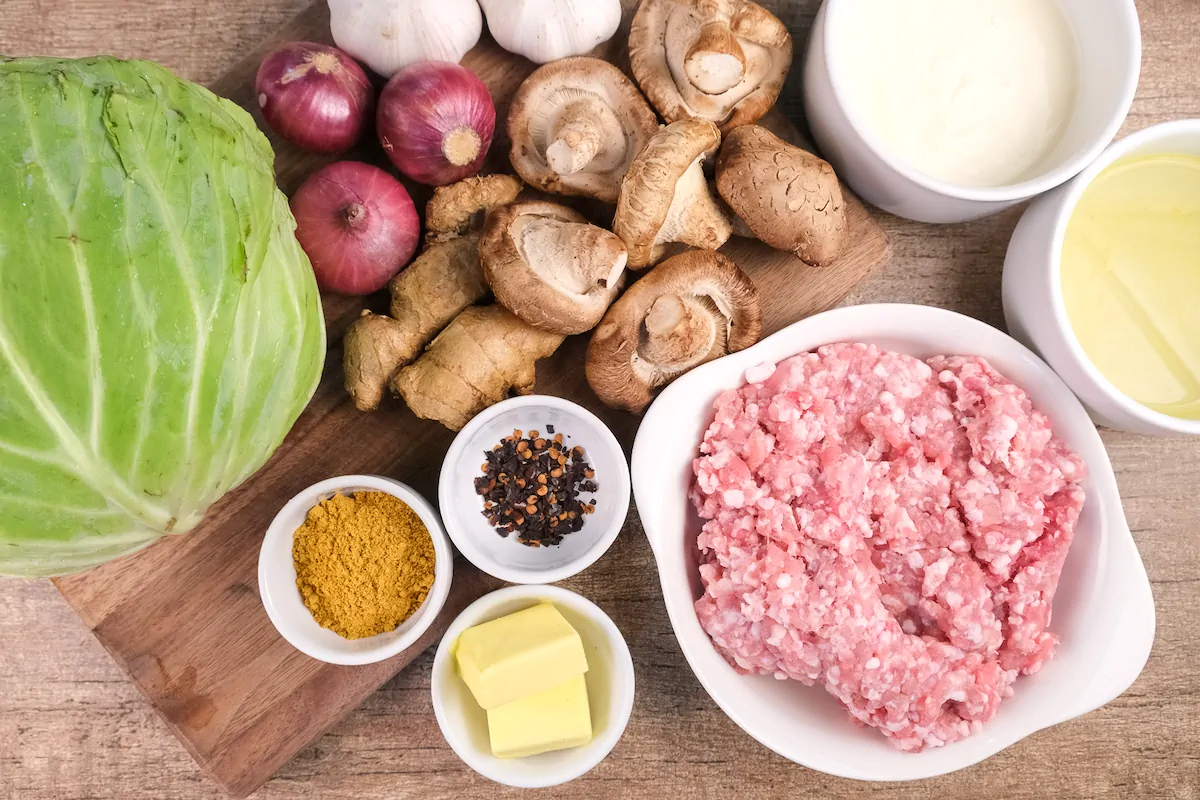 All the ingredients required to make keto cabbage rolls gathered and arranged on the table.