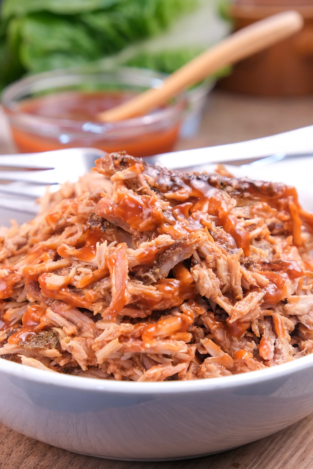 Keto pulled pork served in a bowl with a fork.