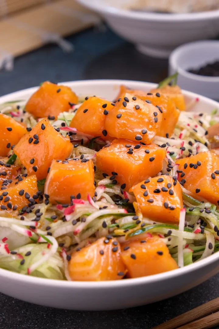 Keto salmon bowl garnished with black toasted sesame seeds.