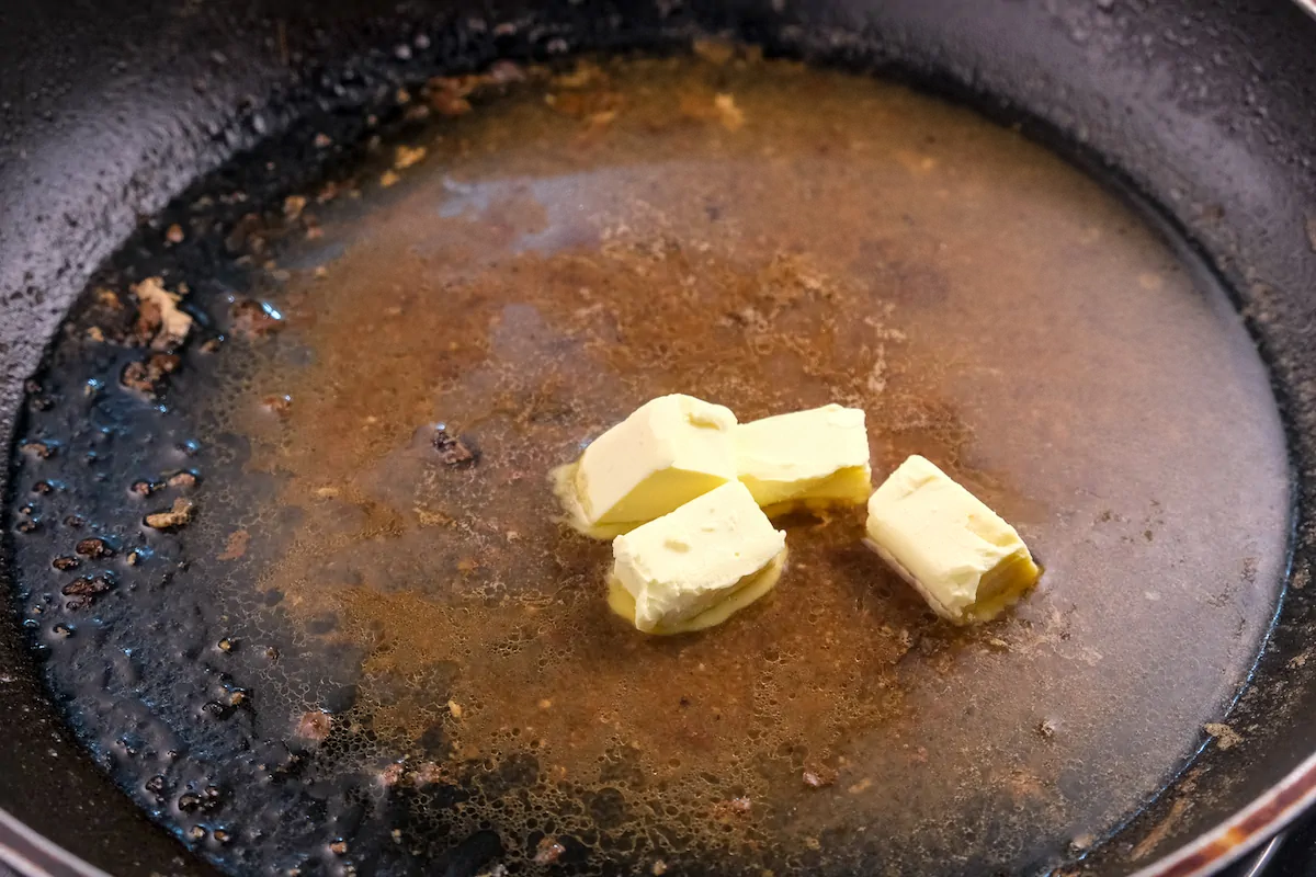Butter added to the pan with pork juices.