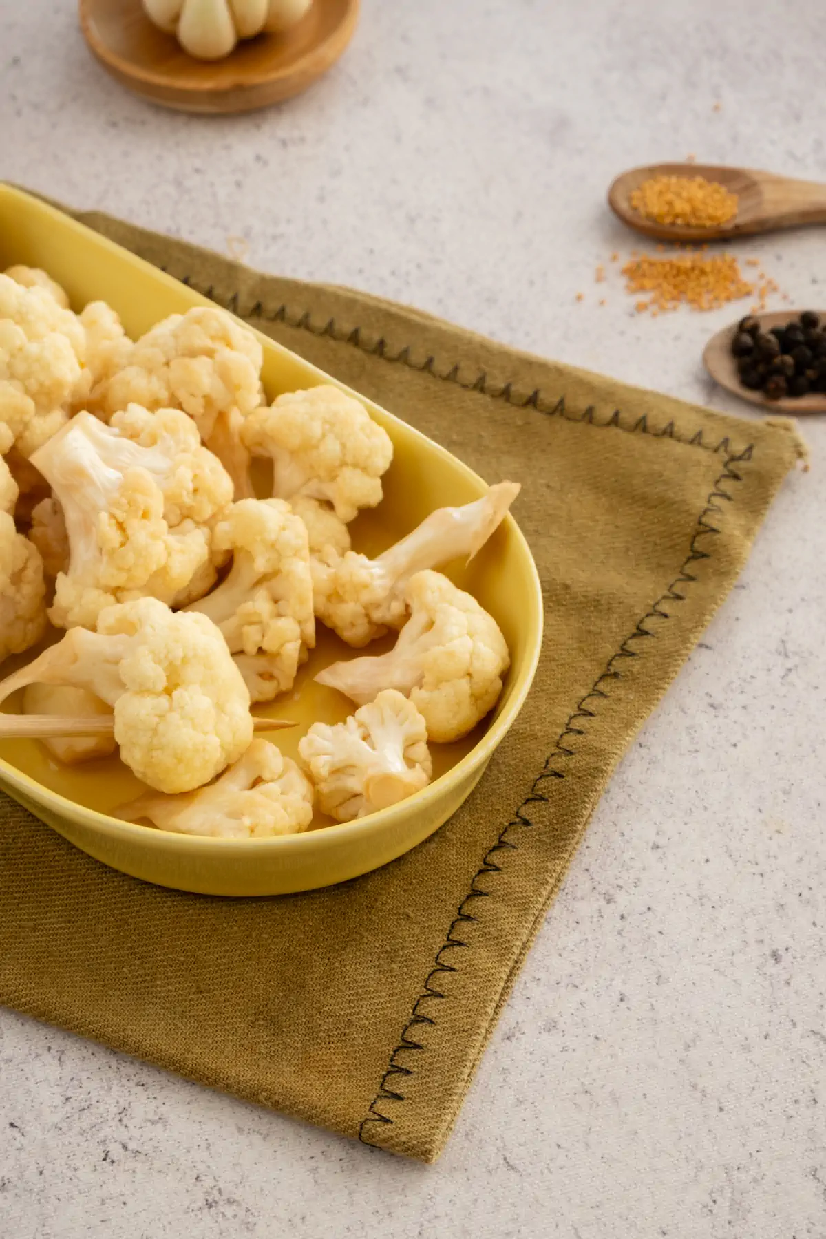 A focused picture of pickled cauliflowers served on a plate.