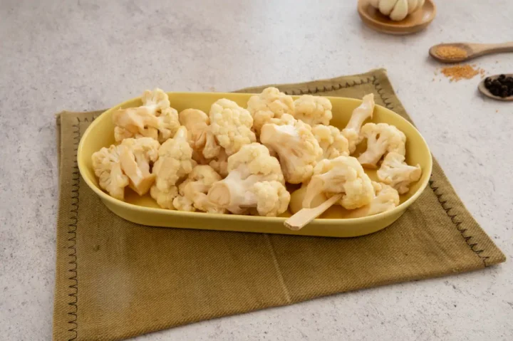 Homemade pickled cauliflowers arranged on a plate.