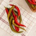 Homemade pepper pickles served on a white plate.