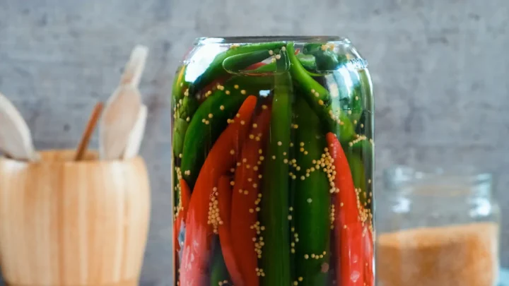 The jar of peppers and brine placed upside down.